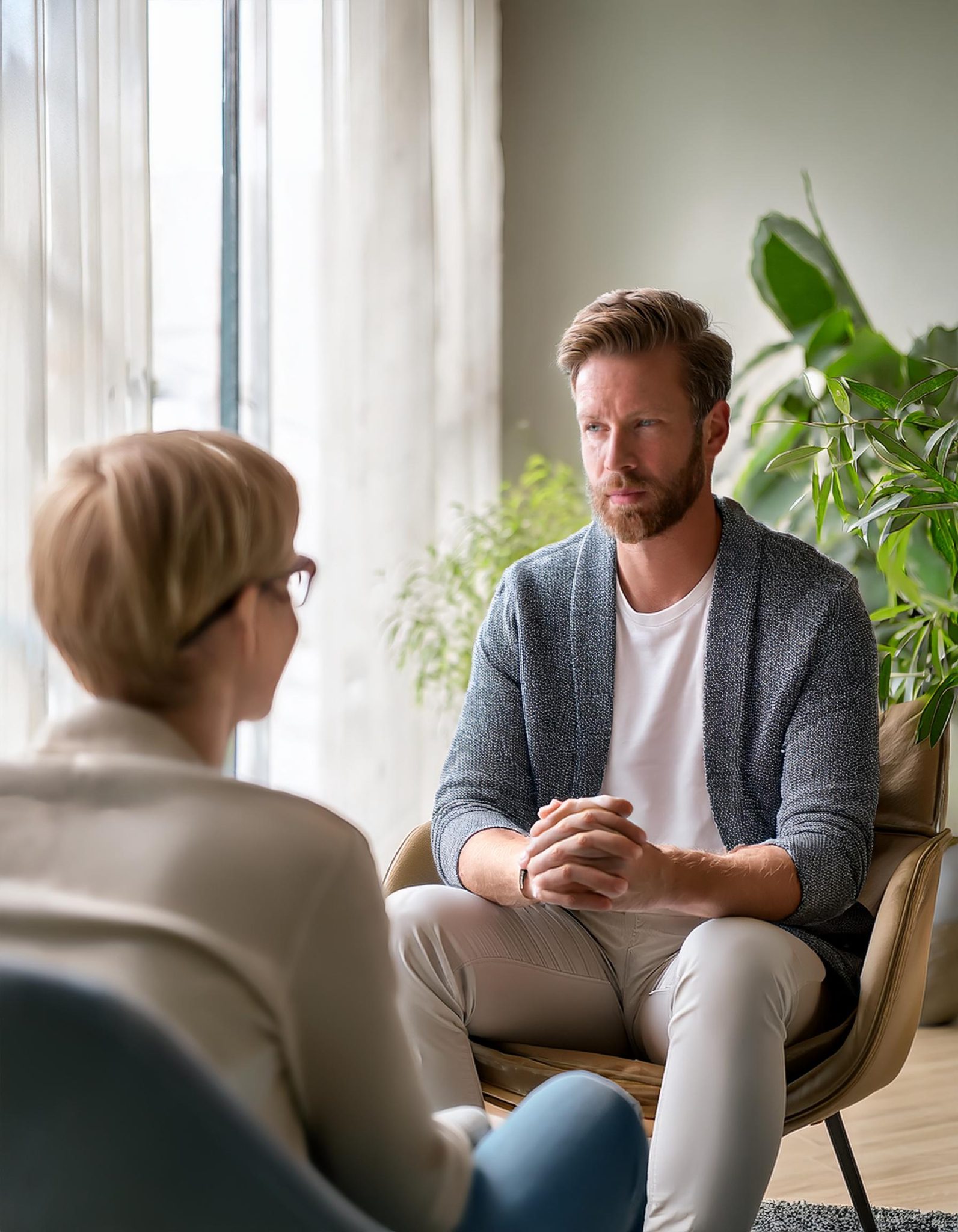 Firefly A compassionate therapist engaging in a one on one session with a client both seated comfor scaled