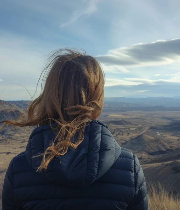 woman-standing-hill-overlooking-valley-page