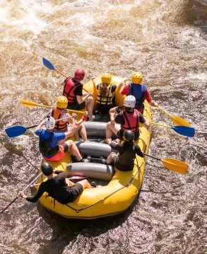 people in a raft doing the white water rafting excursion